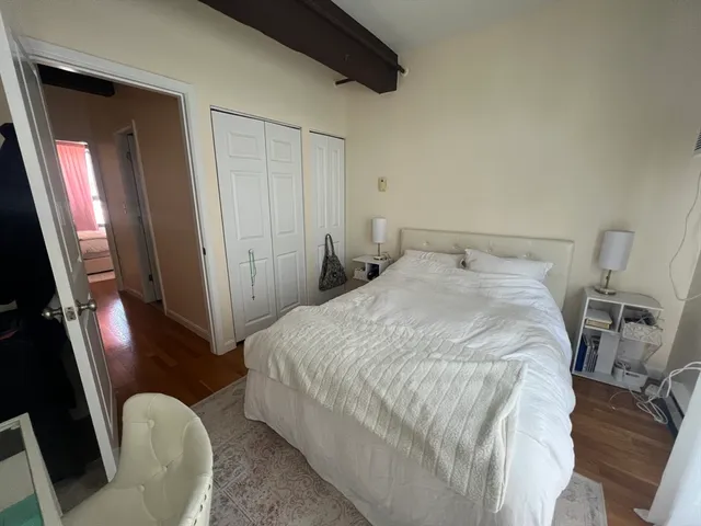 a bedroom with a bed and a mirror