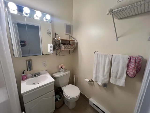 a bathroom with a sink a toilet and mirror