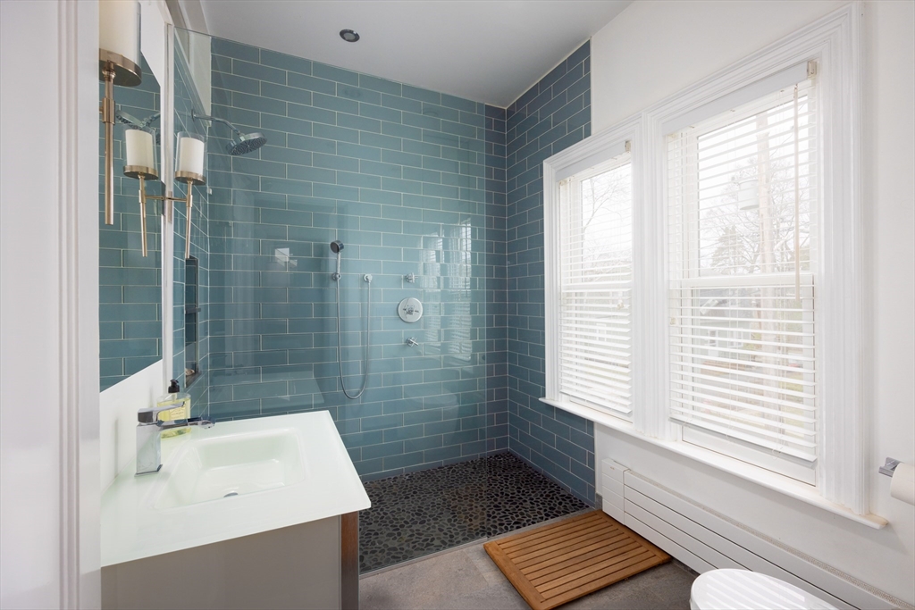 75 Clinton Place Newton, MA 02459 - Photo 11 of 18 a bathroom with a sink a toilet a mirror and shower