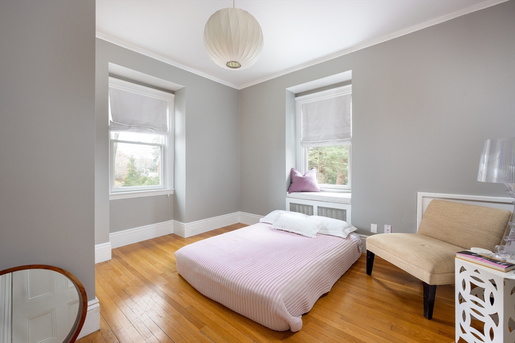 75 Clinton Place Newton, MA 02459 - Photo 12 of 18 a bedroom with a bed and wooden floor