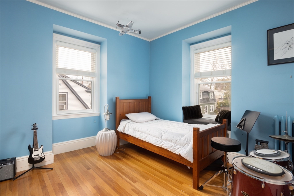 75 Clinton Place Newton, MA 02459 - Photo 14 of 18 a bedroom with a bed and wooden floor