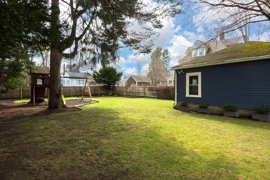 75 Clinton Place Newton, MA 02459 - Photo 18 of 18 a view of a yard with a house and a large tree