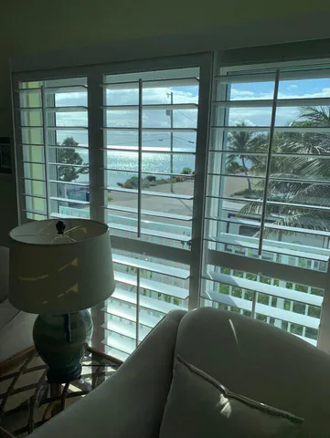 a kitchen with a sink window and cabinets