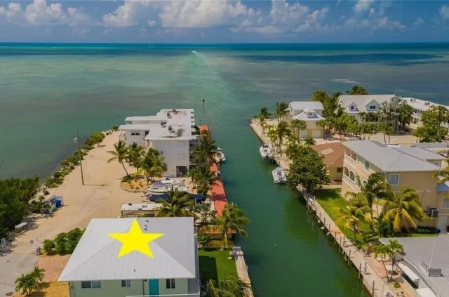 an aerial view of a house with a lake view