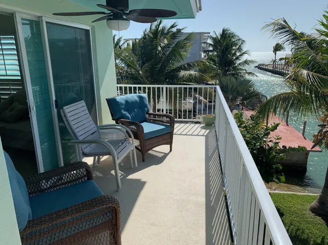 a kitchen with stainless steel appliances granite countertop a sink a stove a dining table and chairs