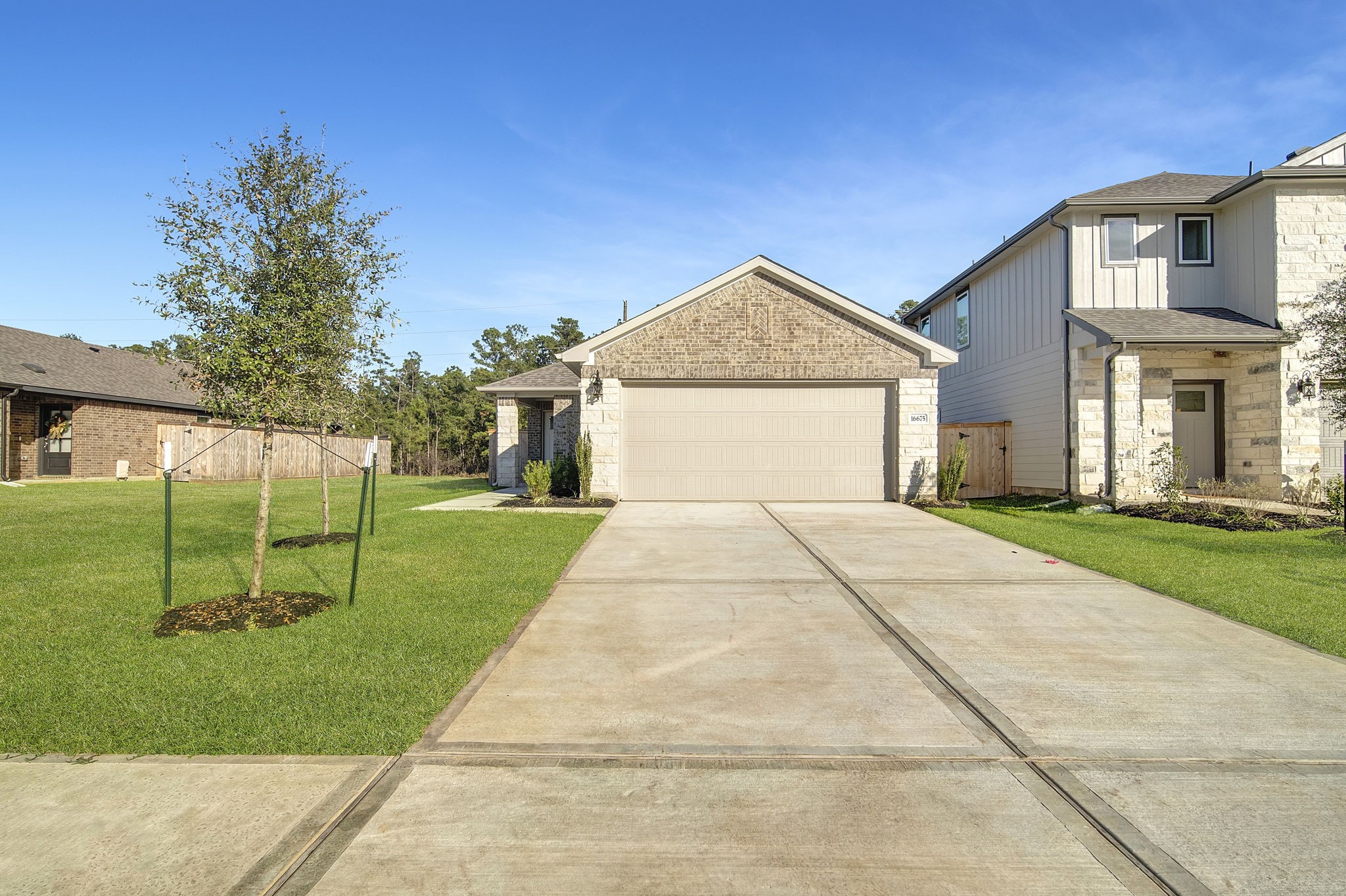 a front view of a house with a yard and trees