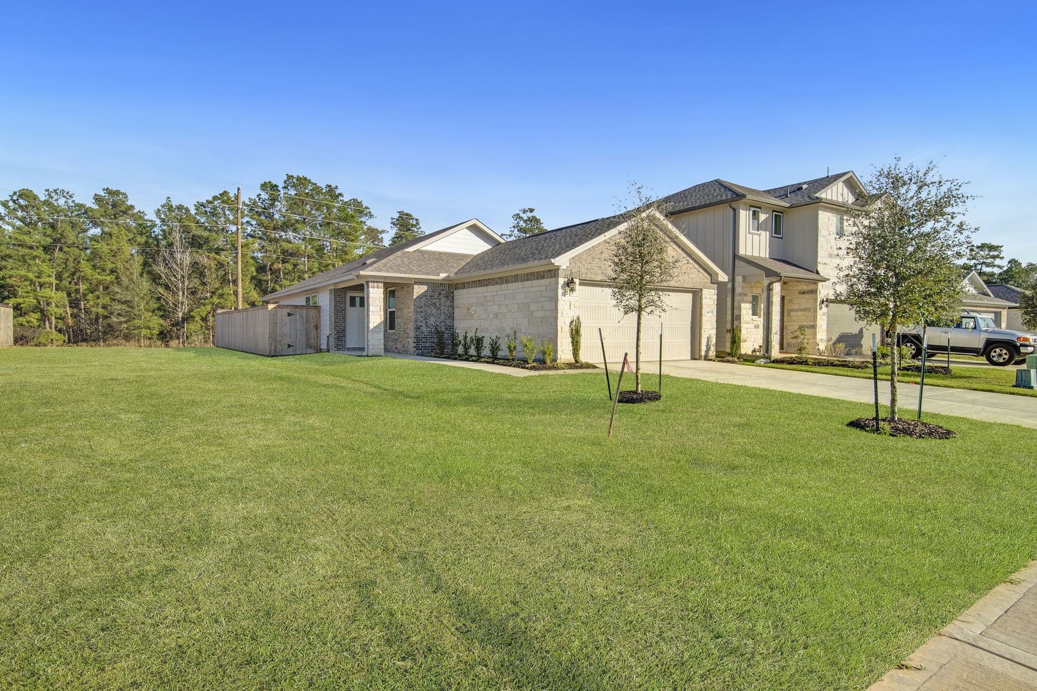 16675 Sterling Clf Street Conroe, TX 77302 - Photo 18 of 21 a view of a house with a big yard and large trees