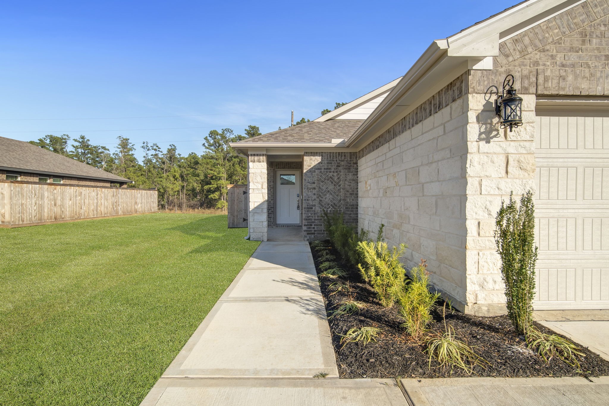 16675 Sterling Clf Street Conroe, TX 77302 - Photo 2 of 21 a front view of a house with garden