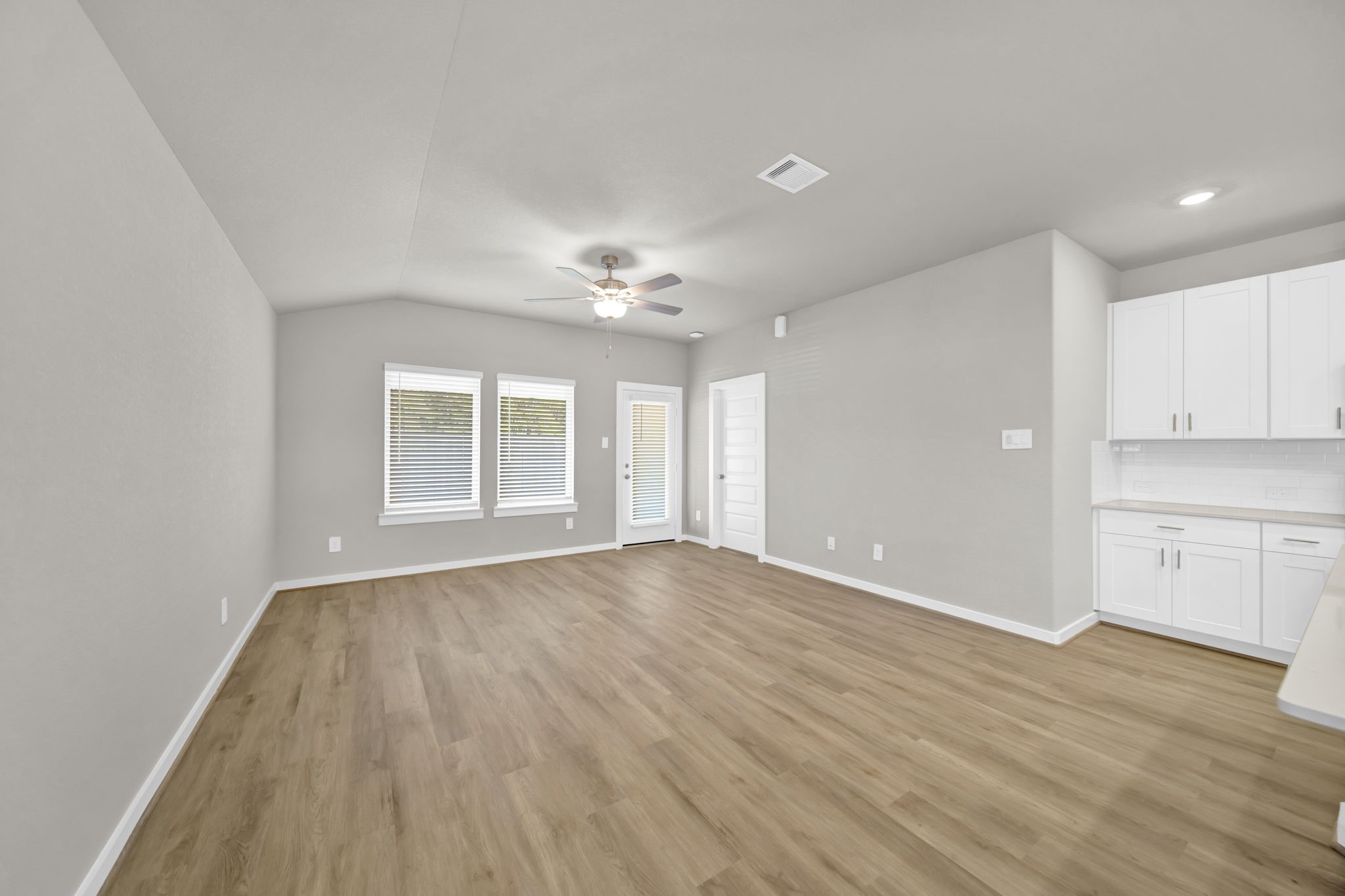 16675 Sterling Clf Street Conroe, TX 77302 - Photo 7 of 21 a view of an empty room with wooden floor and a window