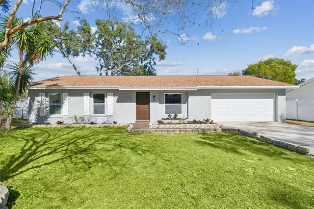 a view of a house with pool and chairs