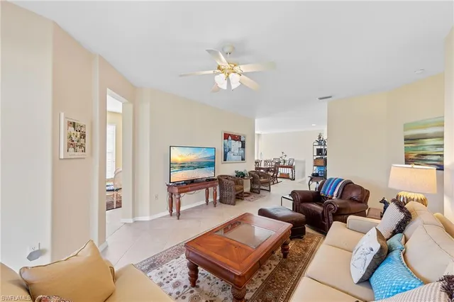 a living room with furniture a rug and a window