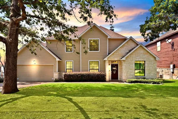 a front view of house with yard and green space