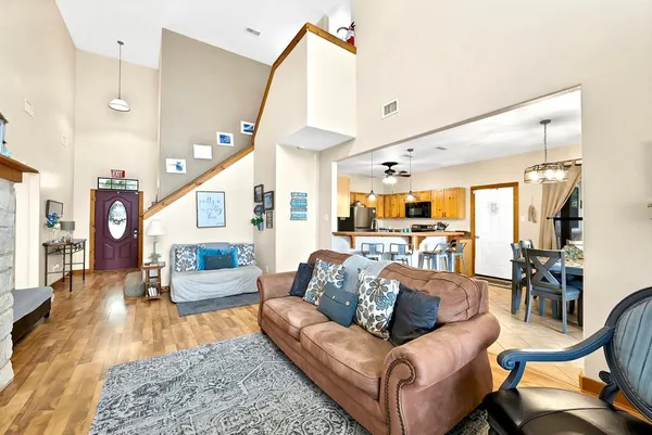 a living room with furniture and wooden floor