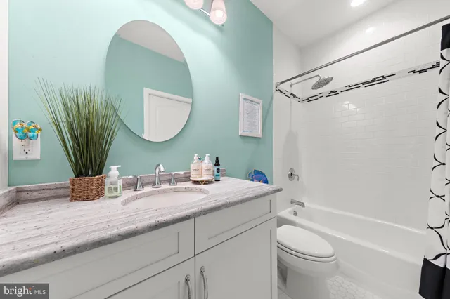 a bedroom with a bed and ceiling fan