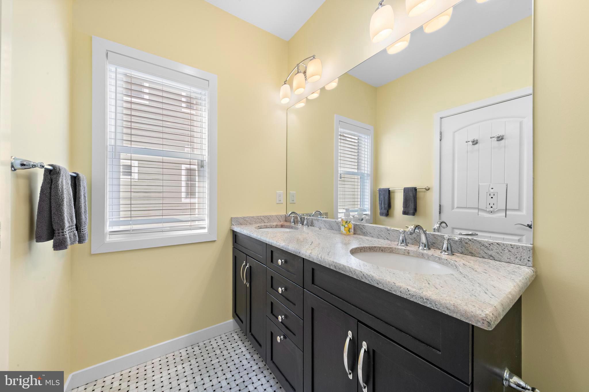 27 West 33rd Street Long Beach Township, NJ 08008 - Photo 22 of 83 a bathroom with a sink and a mirror