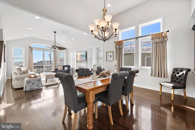 a living room with furniture a fireplace and large windows