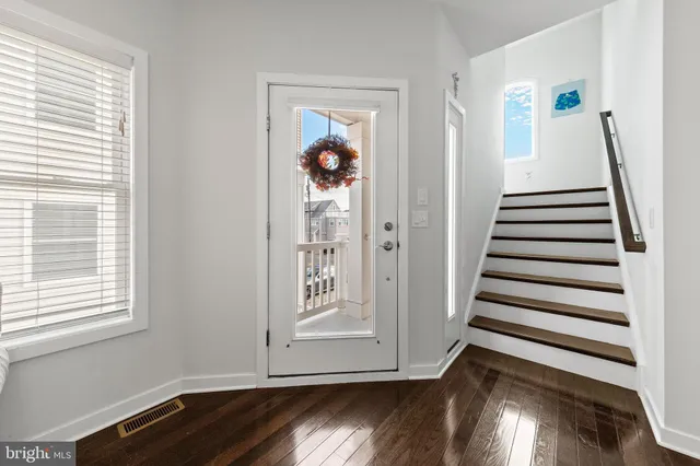 a living room with furniture window and wooden floor