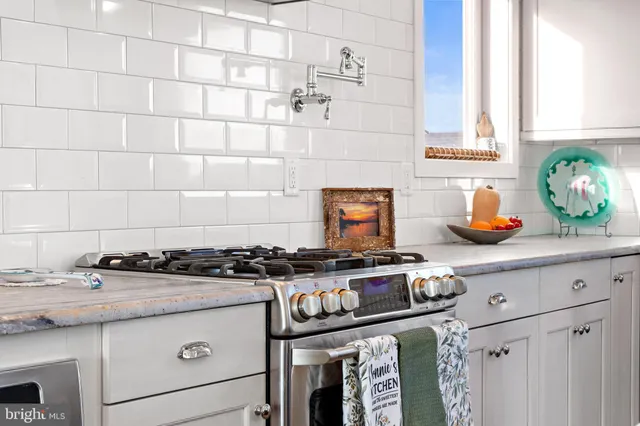 a view of a hallway with wooden floor and a living room