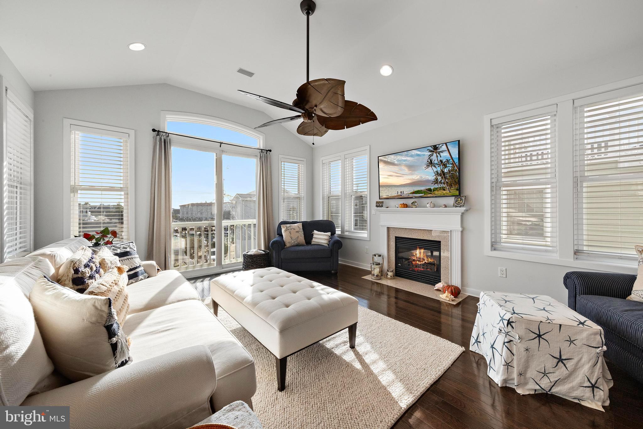 27 West 33rd Street Long Beach Township, NJ 08008 - Photo 36 of 83 a living room with furniture a fireplace and large windows
