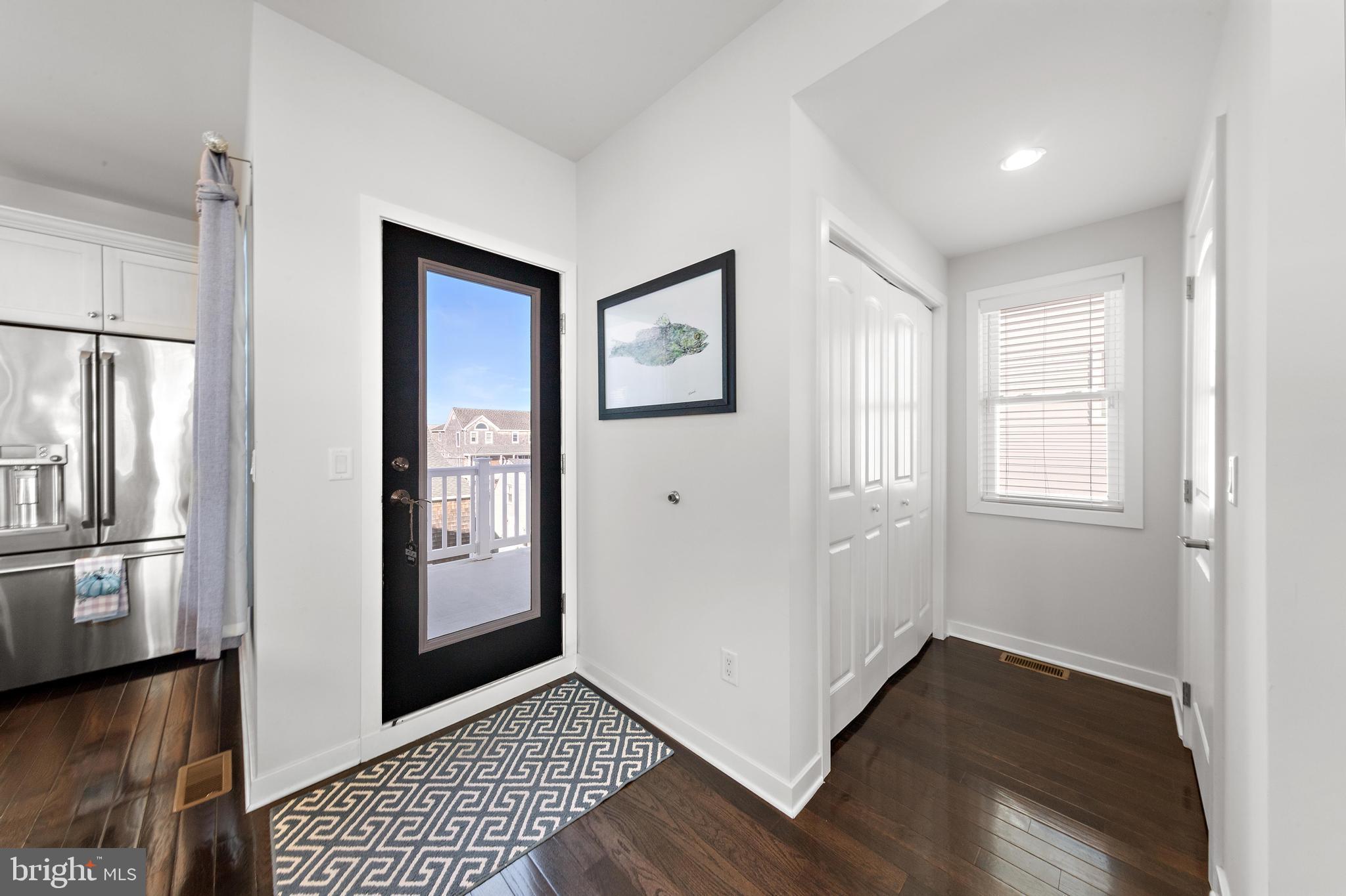 27 West 33rd Street Long Beach Township, NJ 08008 - Photo 46 of 83 a view of a hallway with wooden floor and a living room