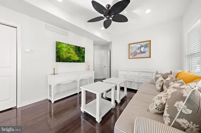 a bathroom with a granite countertop sink mirror vanity and toilet