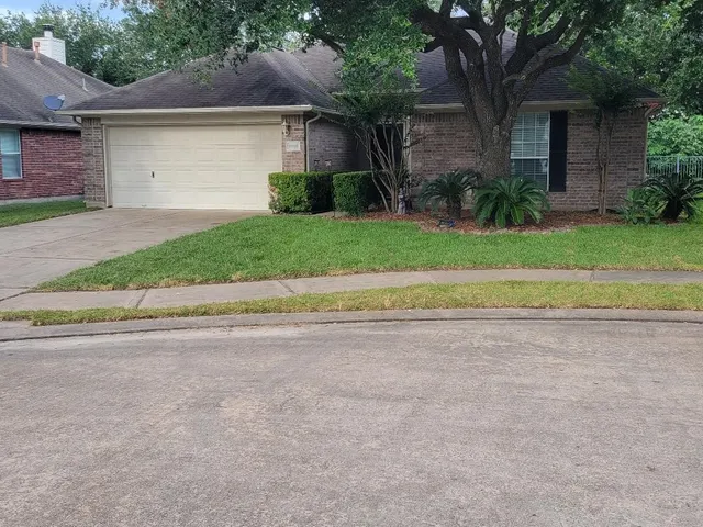 a front view of a house with a yard and a garage