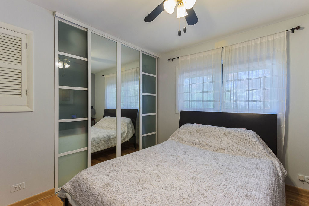 789 Ridge Road Highland Park, IL 60035 - Photo 17 of 36 a bedroom with a large bed and a chandelier