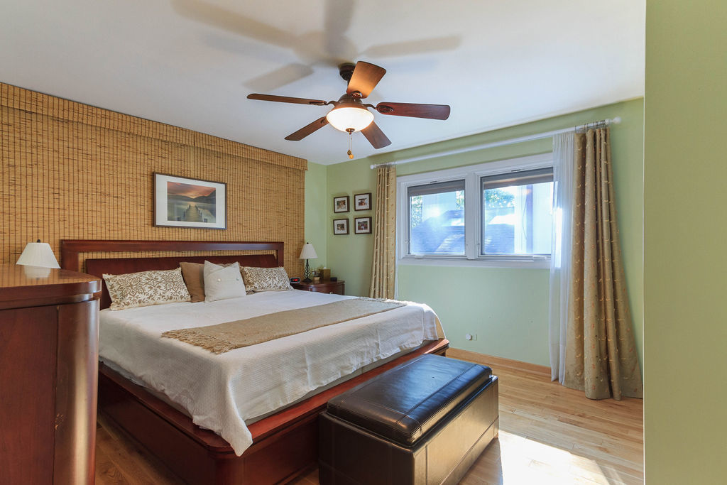 789 Ridge Road Highland Park, IL 60035 - Photo 18 of 36 a bedroom with a bed and a chandelier