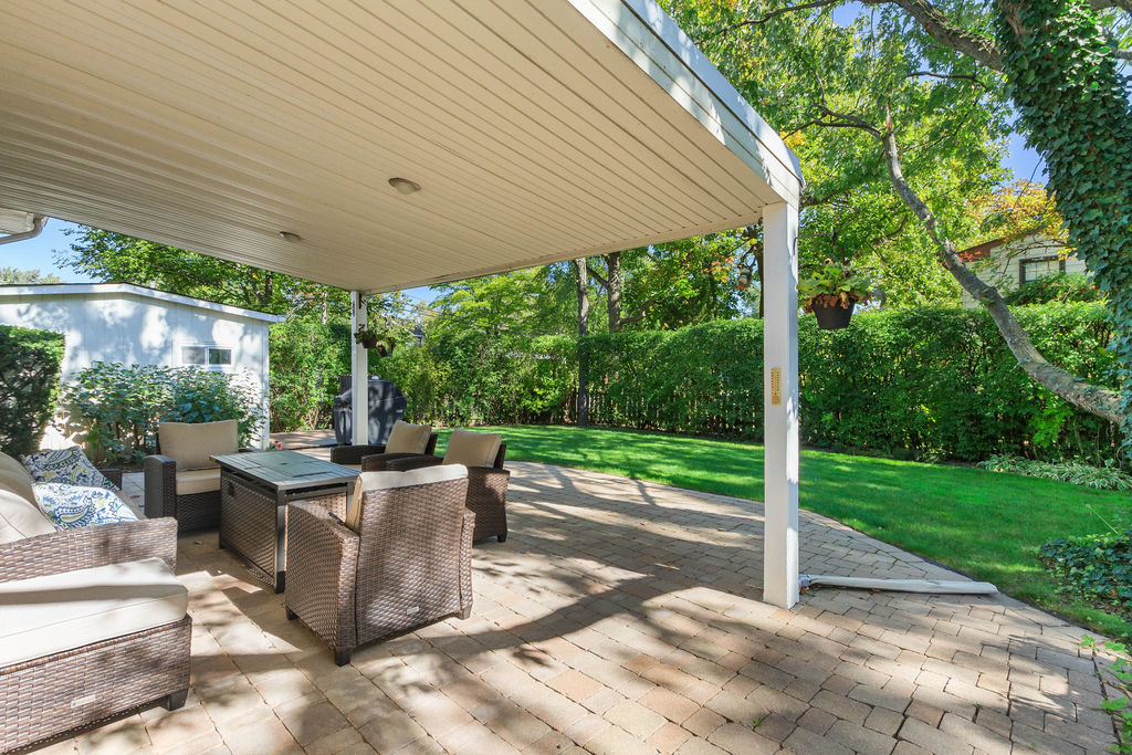 789 Ridge Road Highland Park, IL 60035 - Photo 6 of 36 a view of a patio with a table chairs and a backyard