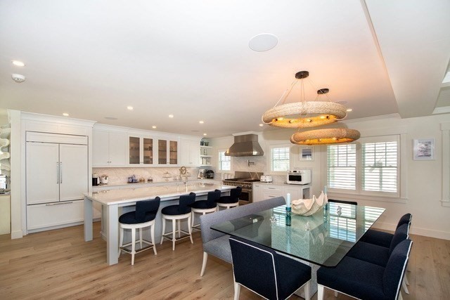a large kitchen with a table and chairs
