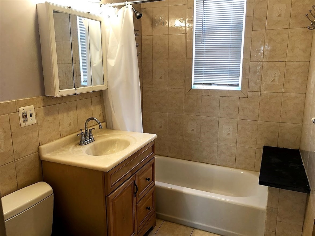 28 Litchfield Street, Unit 3 Boston, MA 02135 - Photo 3 of 11 a bathroom with a sink and a bathtub