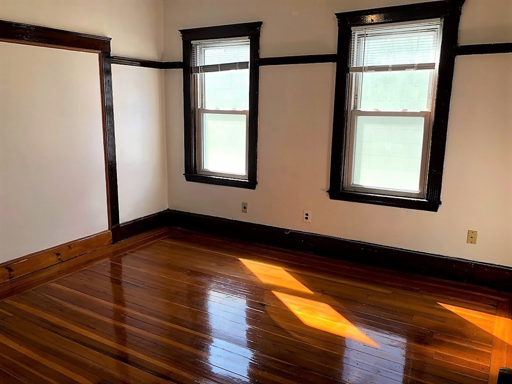 28 Litchfield Street, Unit 3 Boston, MA 02135 - Photo 4 of 11 a view of an empty room with wooden floor and a window