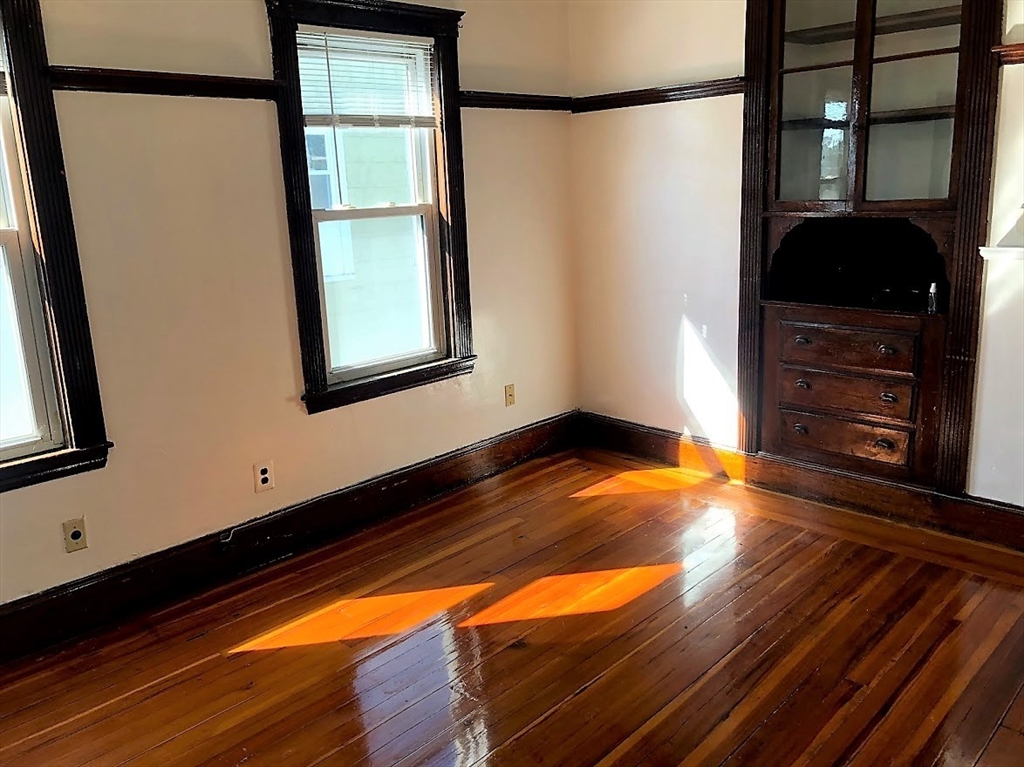 28 Litchfield Street, Unit 3 Boston, MA 02135 - Photo 5 of 11 a view of empty room with wooden floor and fan