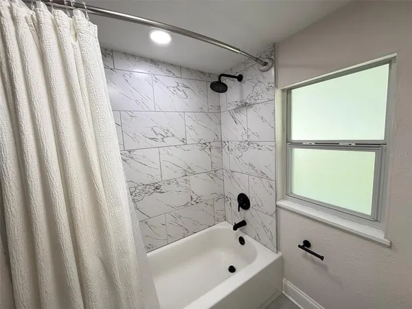 a bathroom with a bathtub and a shower