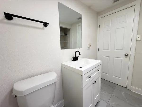 a view of bathroom with a sink and mirror