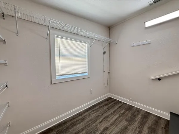 a view of a room with wooden floor and windows