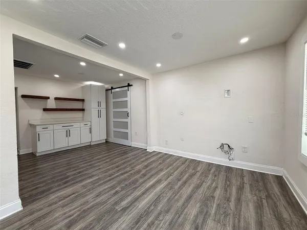 a view of a kitchen with wooden floor and a sink