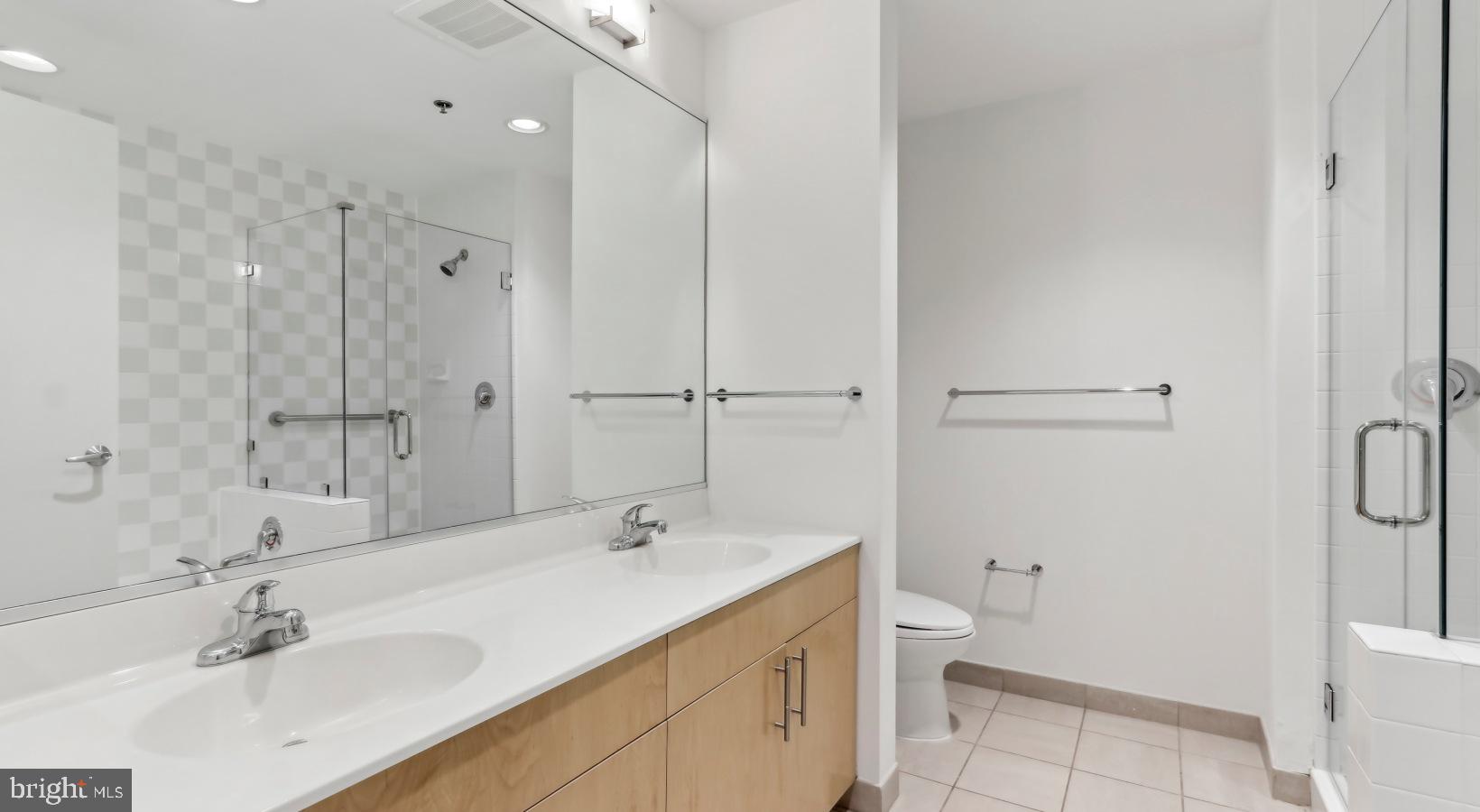 206 West Washington Square, Unit 1908 Philadelphia, PA 19106 - Photo 23 of 31 a bathroom with a double vanity sink toilet and shower