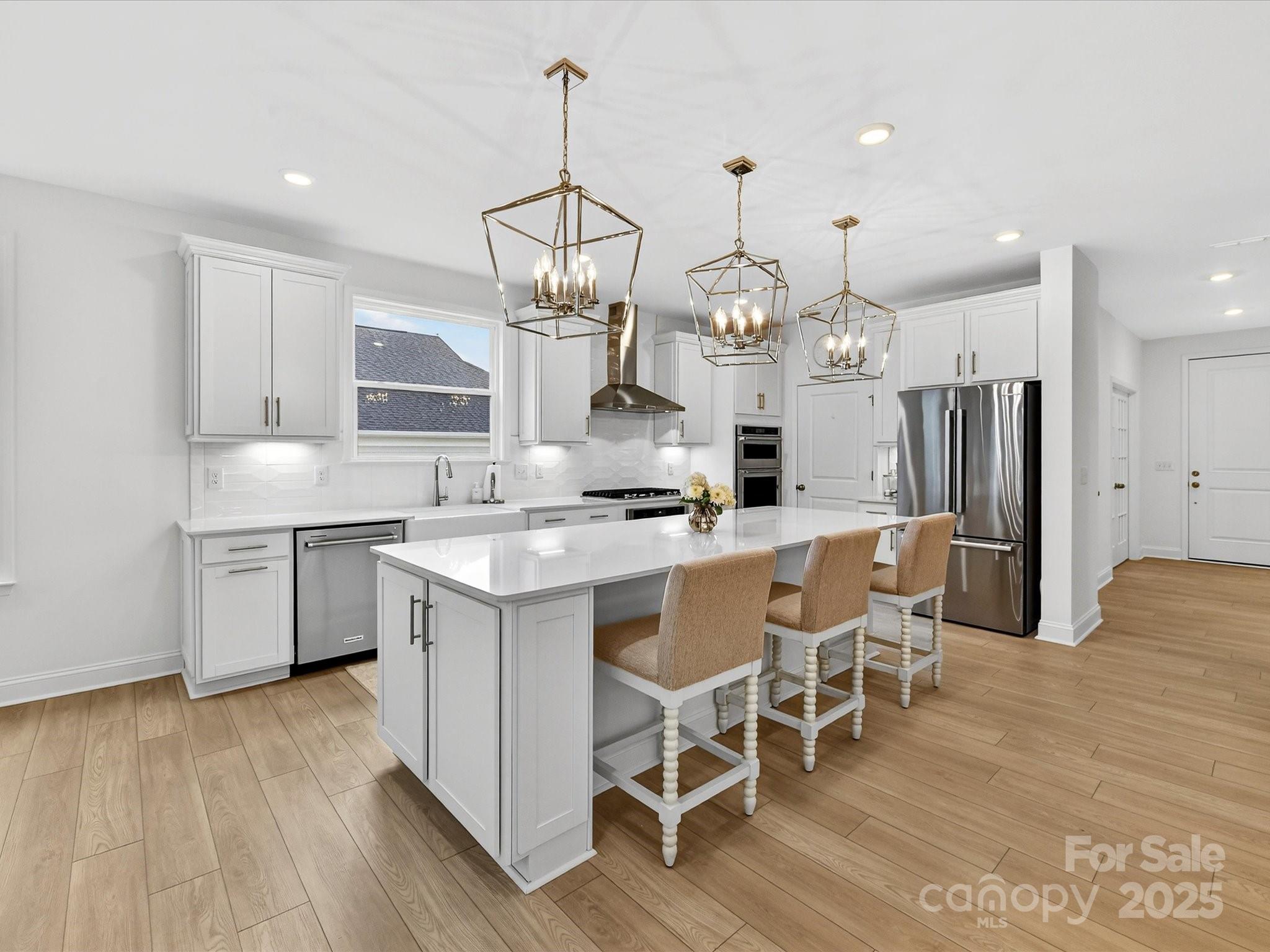 4790 Formation Court Lancaster, SC 29720 - Photo 13 of 41 a kitchen with kitchen island stainless steel appliances a dining table chairs and sink