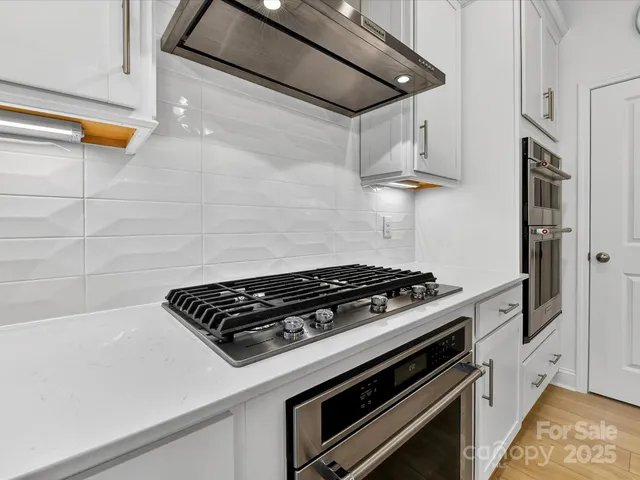 a stove top oven sitting inside of a kitchen