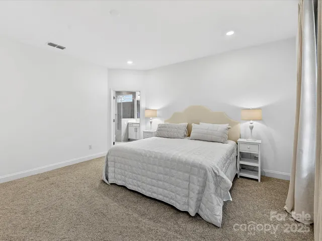 a bedroom with a bed and a lamp