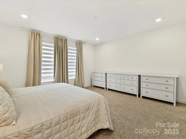 a spacious bedroom with a bed and a window