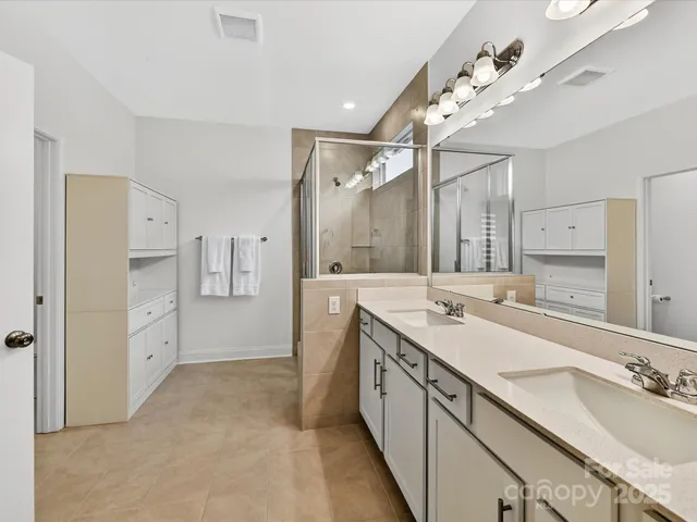 a spacious bathroom with a double vanity sink mirror and double