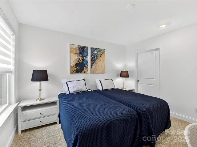 a bedroom with a bed and a night stand