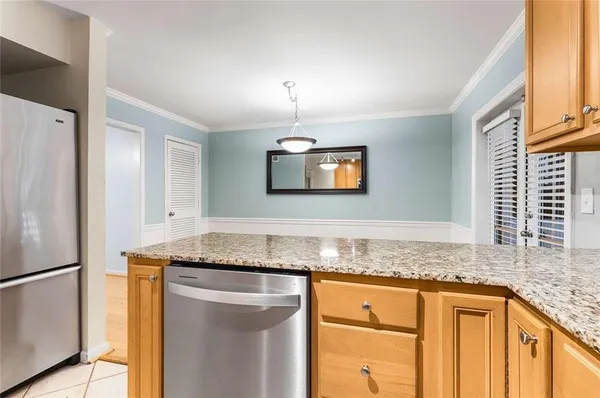 a kitchen with granite countertop cabinets stainless steel appliances and a counter space