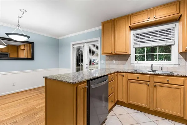a kitchen with granite countertop cabinets sink and window
