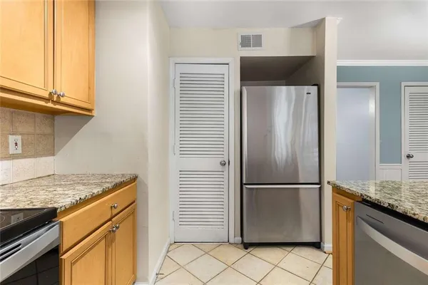 a kitchen with a refrigerator and a sink