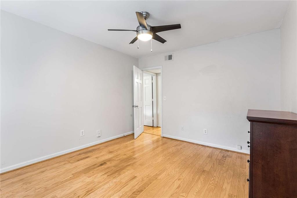 1101 Collier Road Northwest, Unit P2 Atlanta, GA 30318 - Photo 17 of 26 an empty room with ceiling fan and window