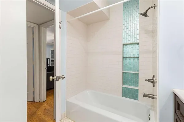 a bathroom with a bathtub and shower
