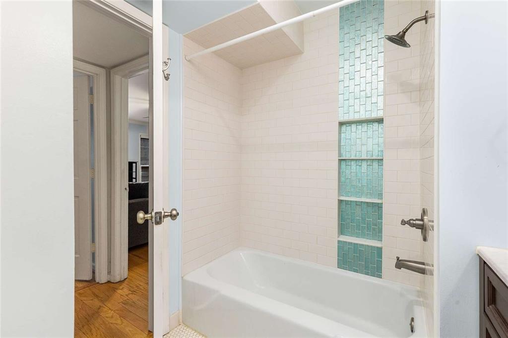 1101 Collier Road Northwest, Unit P2 Atlanta, GA 30318 - Photo 19 of 26 a bathroom with a bathtub and shower